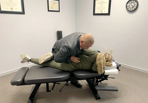 Chiropractor Knoxville TN Josh Rucker Adjusting Patients Lower Back