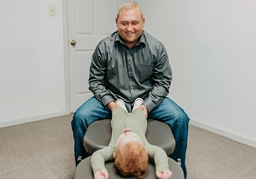 Chiropractor Knoxville TN Josh Rucker Examining Baby